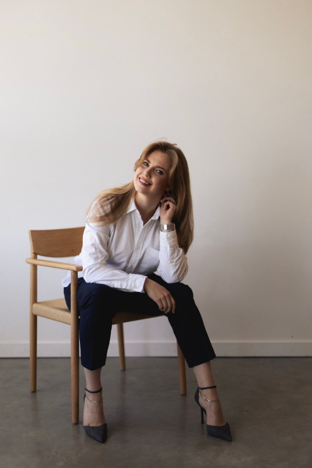 Studio portrait of a Syntri Labs co-founder seated in a chair, smiling.